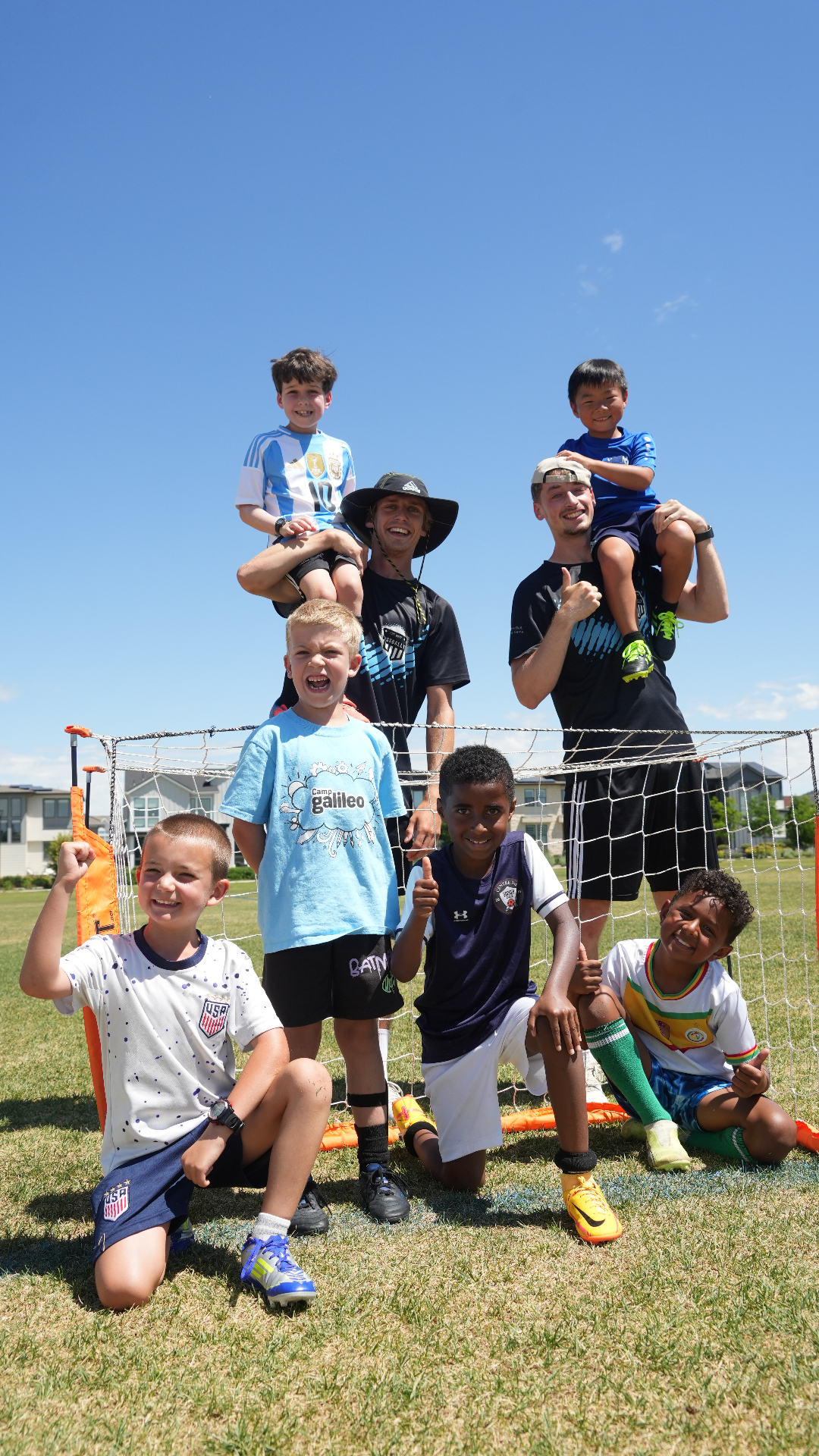Fussbally players and coaches gathered in front of the goal